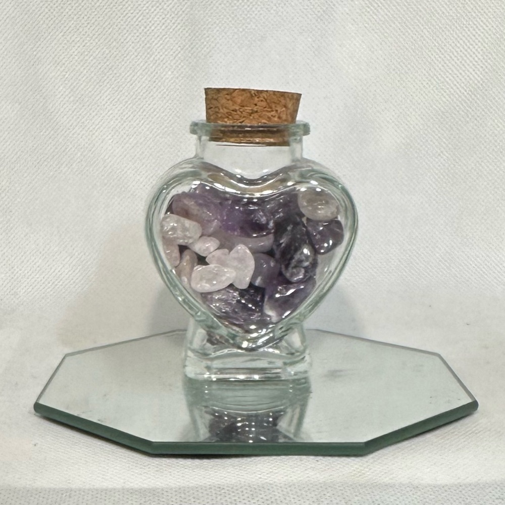 Heart jar filled with Amethyst and Rose Quartz tumbles.